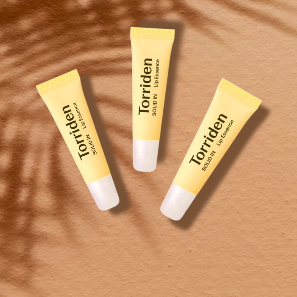 3 tubes of TORRIDEN lip essence on sand - links to solid in lip essence